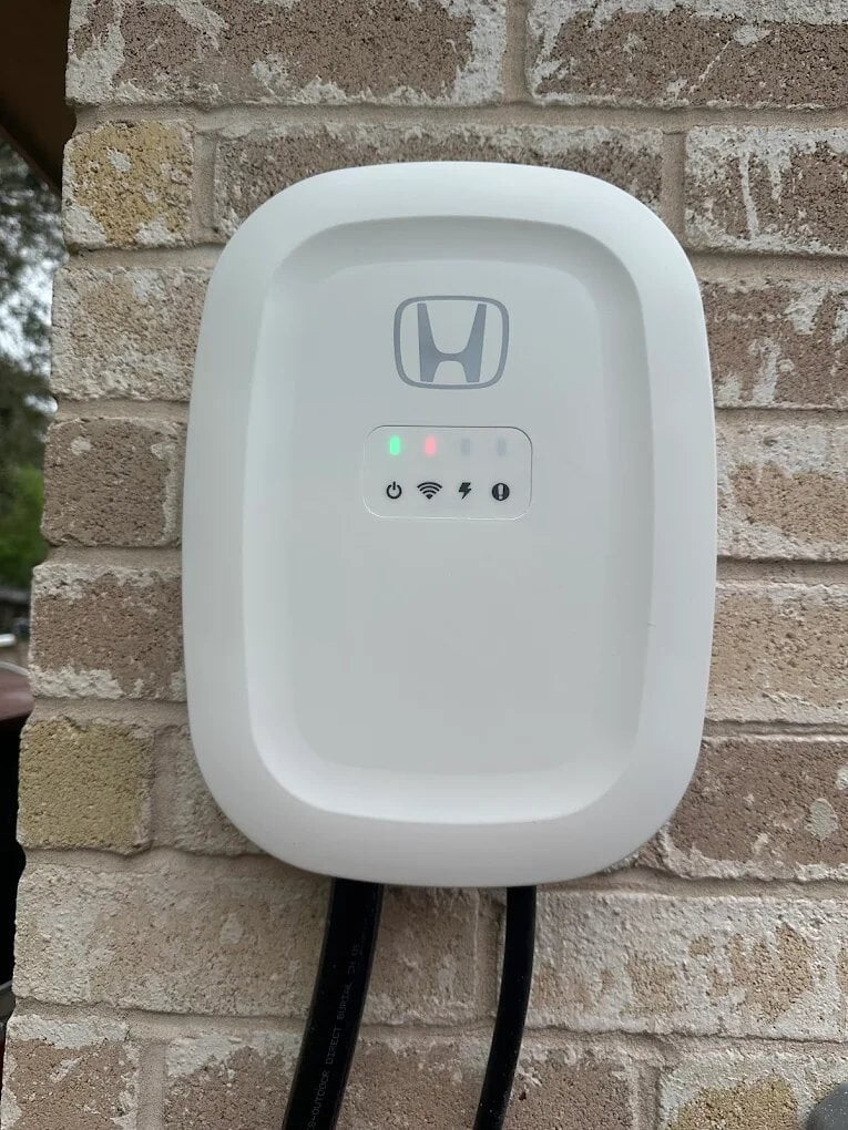 Close-up of a wall-mounted home EV charger installed in Angleton, TX